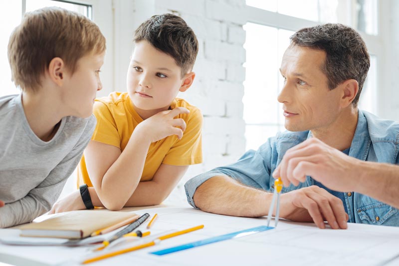 Father giving his children a math lesson